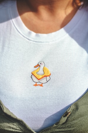 A close up of a person wearing a ducky shirt