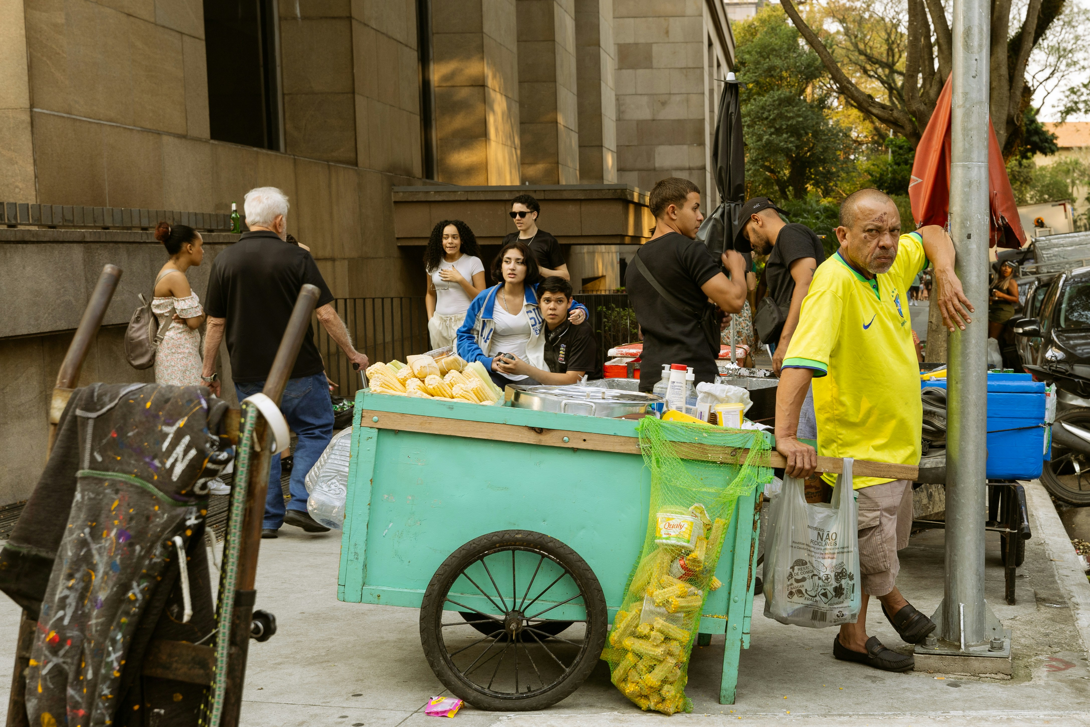 people standing around a street food cart