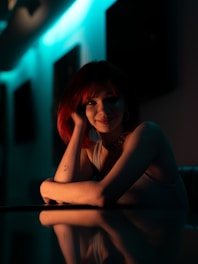 A woman with red hair sitting at a table