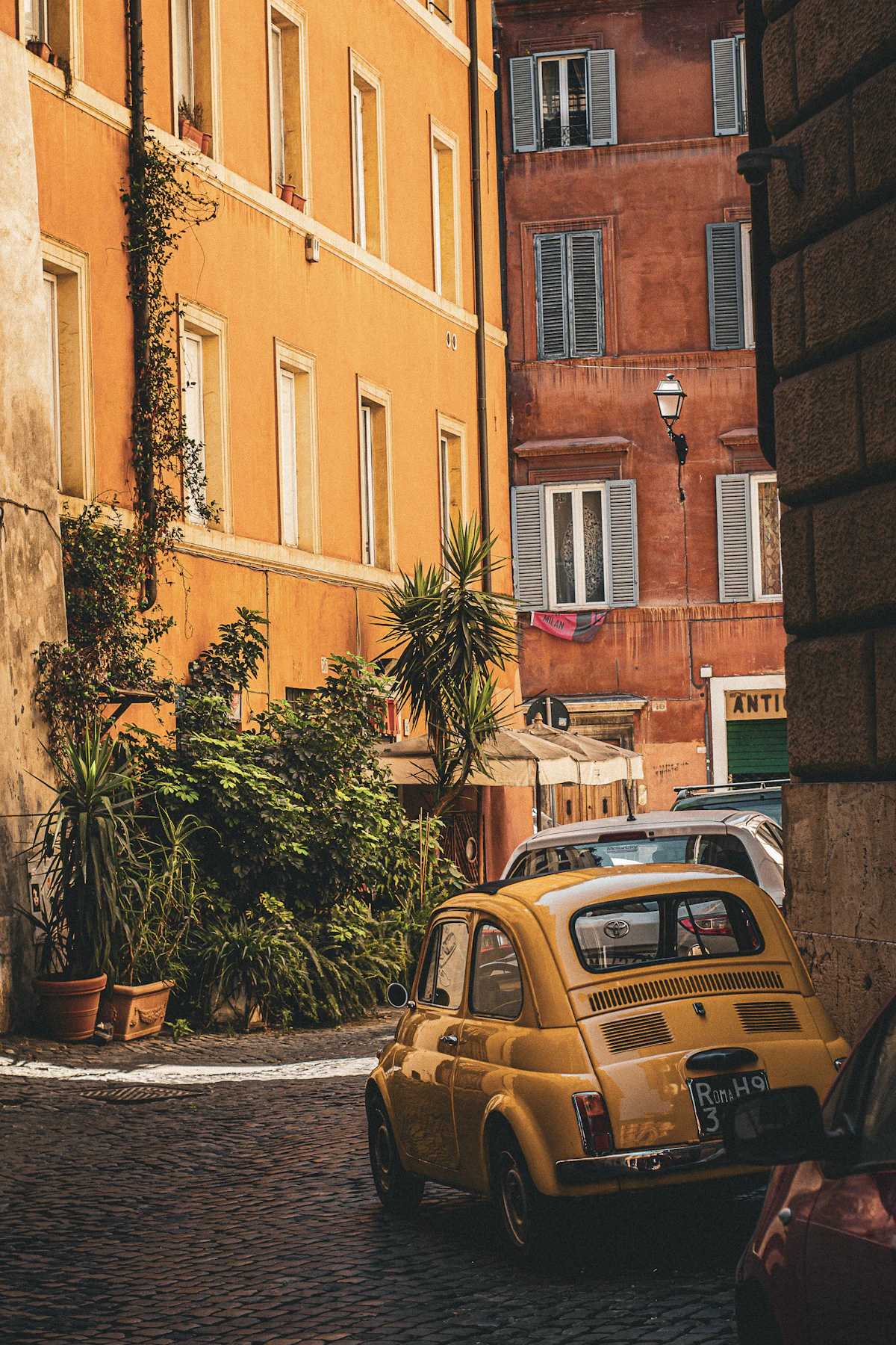 A warm, ivy-draped Trastevere building with shuttered windows in Rome