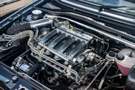 The engine compartment of a car with the hood up