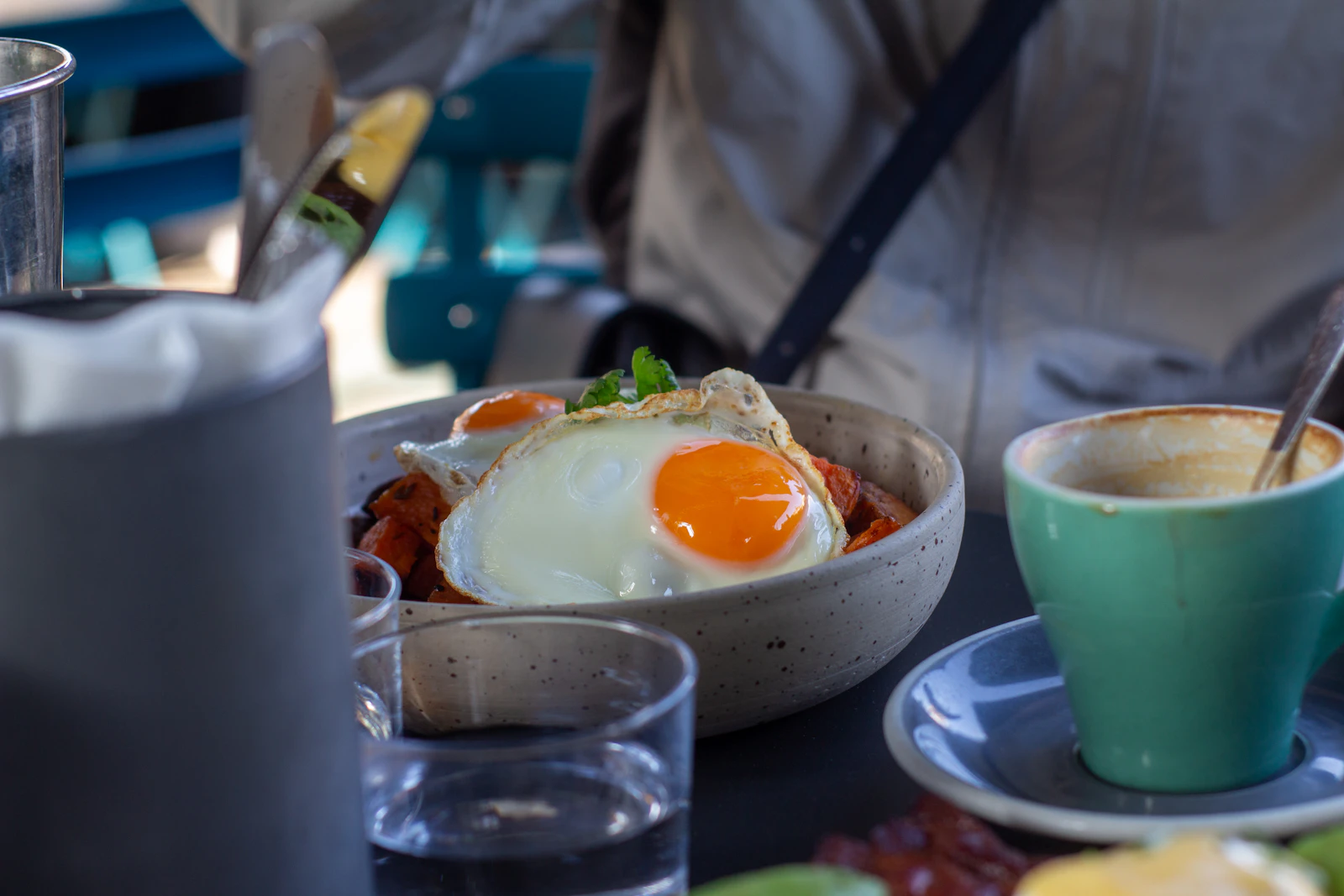 A table topped with plates of food and cups of coffee