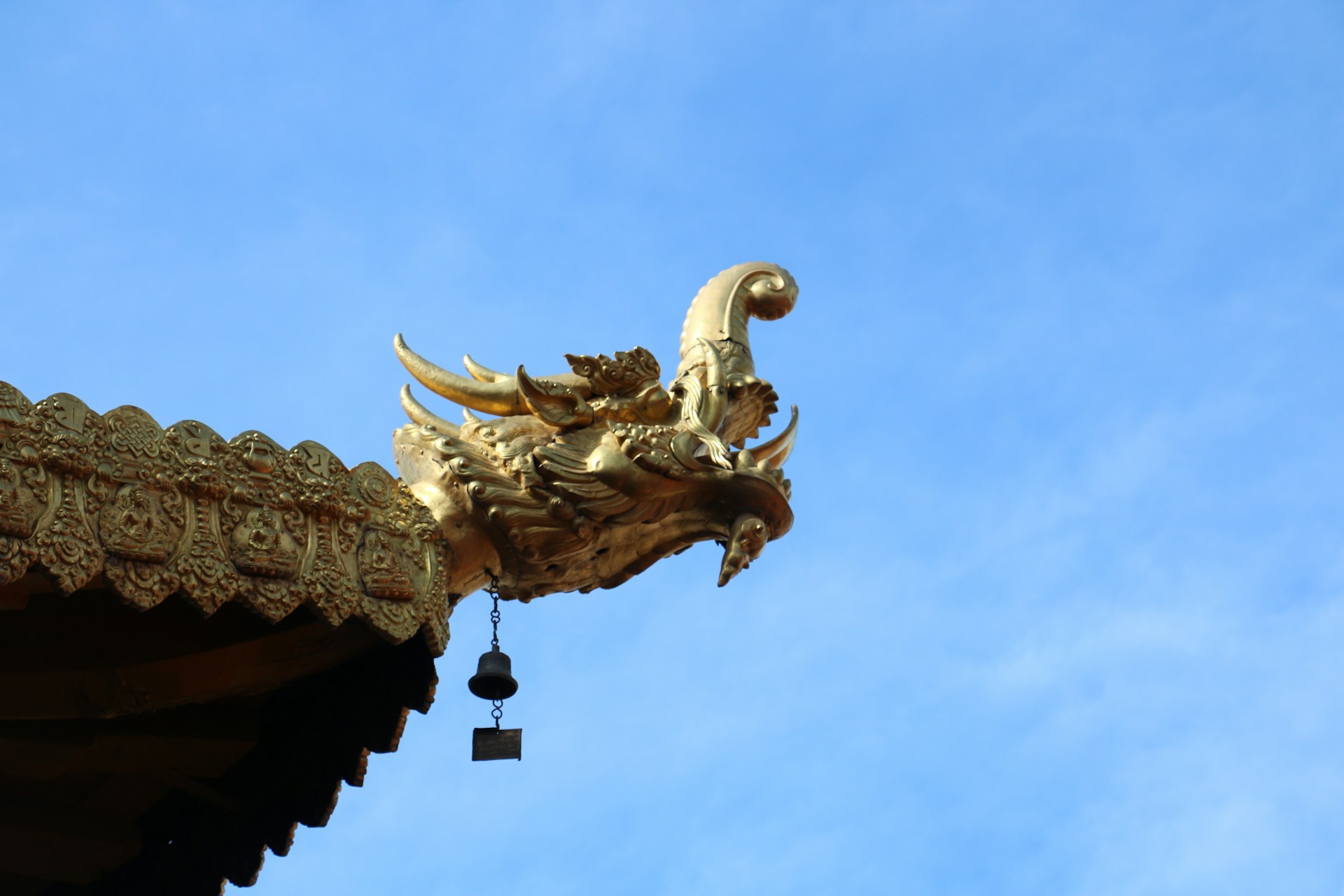 A golden dragon statue on top of a building