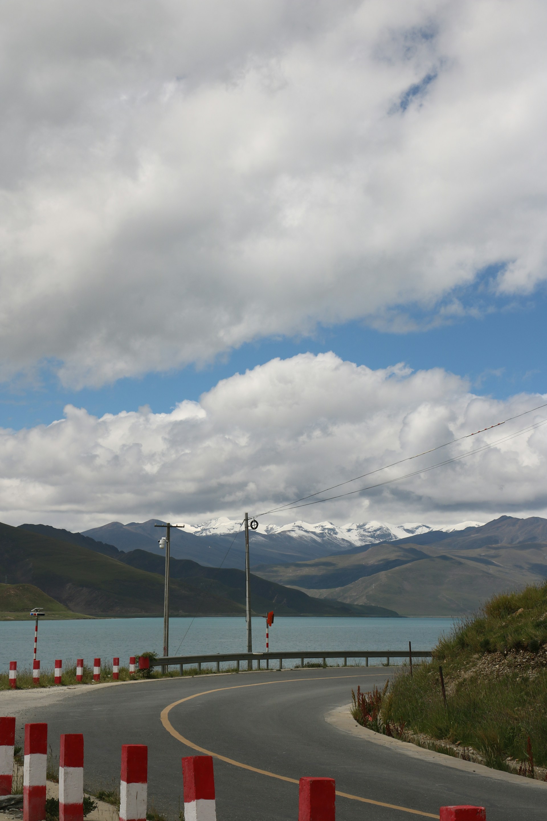 A road that has some red and white cones on it