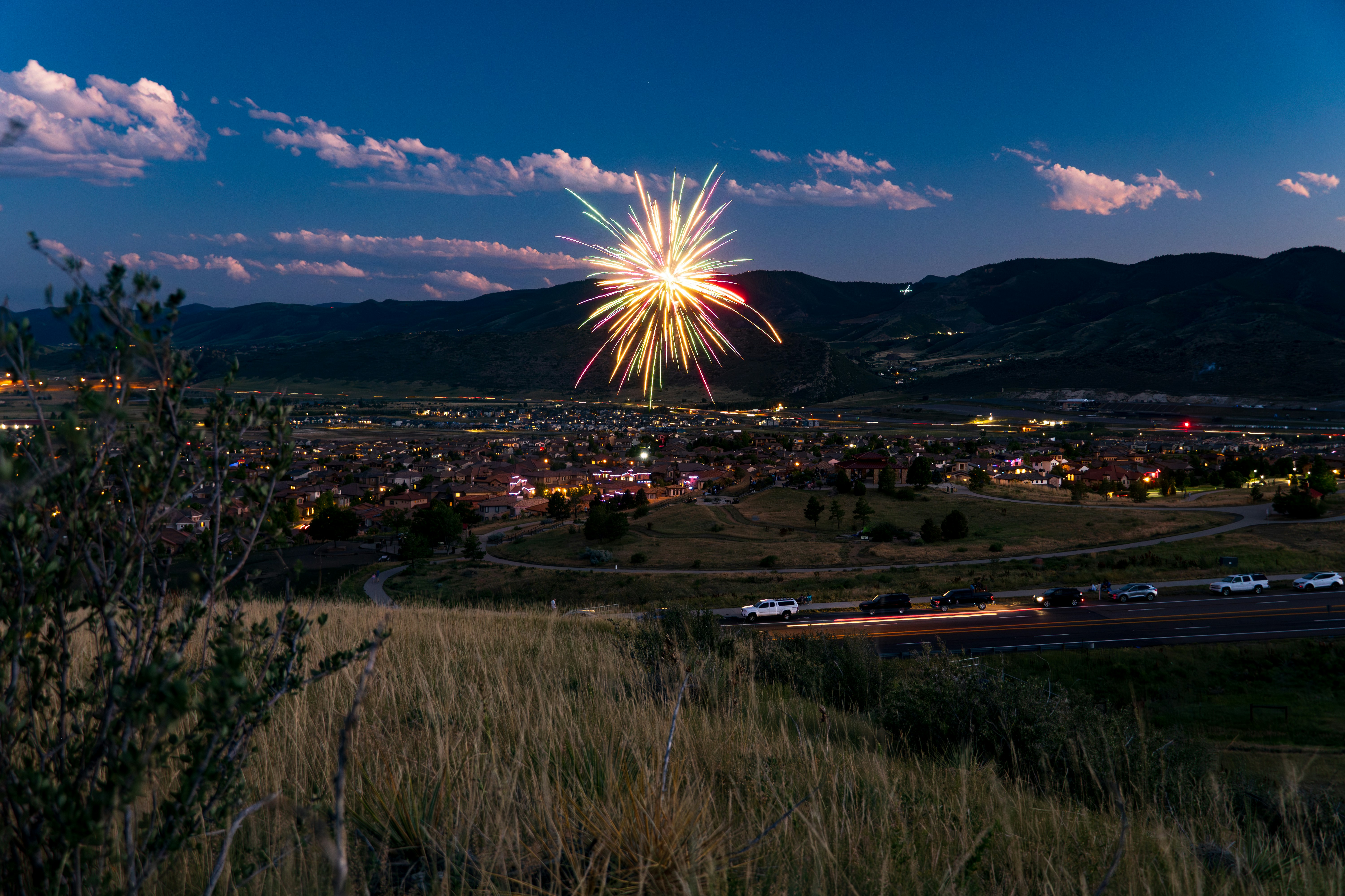 A fireworks display in the sky over a city