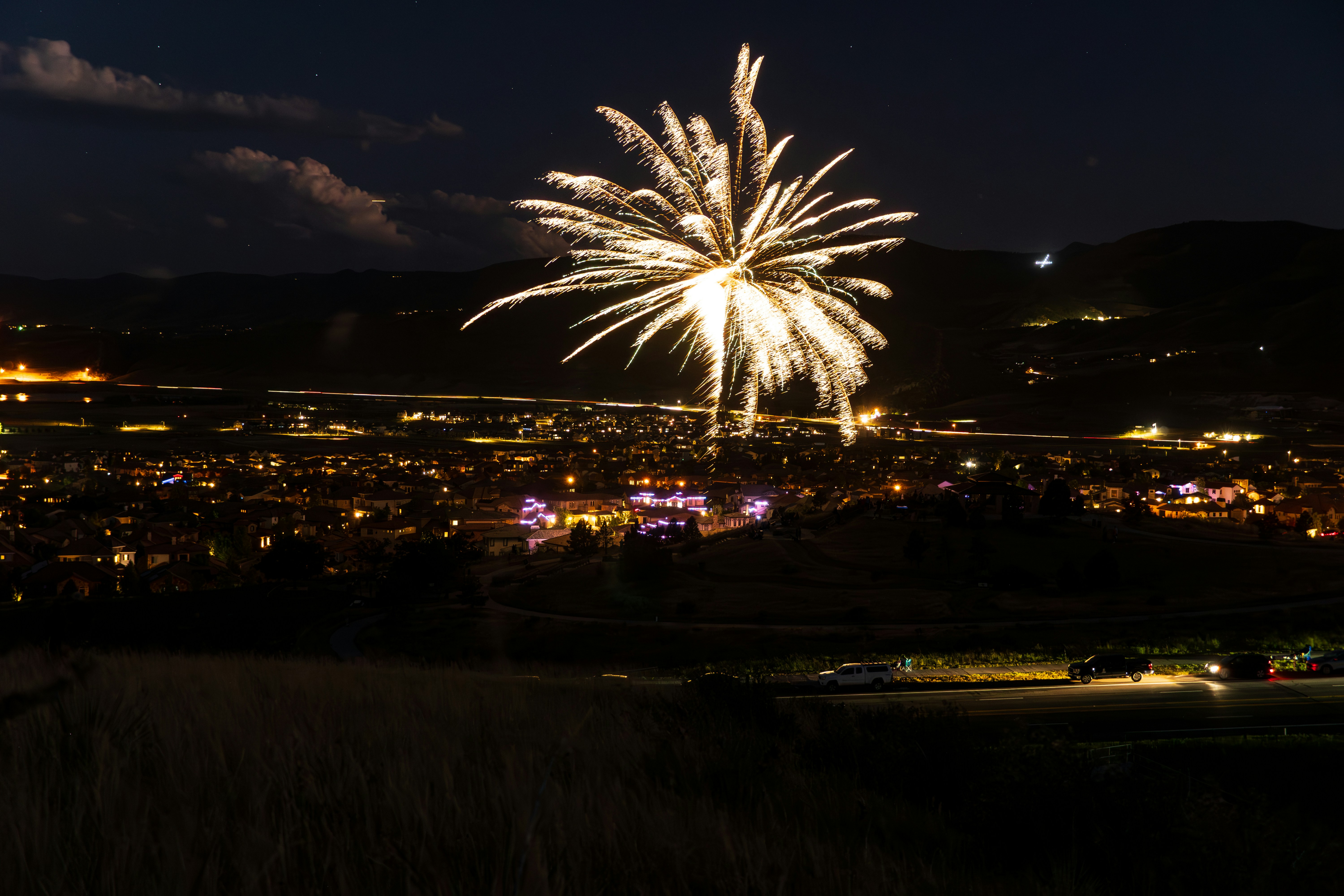 A fireworks display over a city at night
