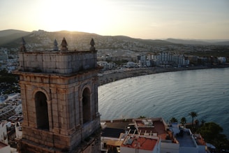 A clock tower overlooking a body of water