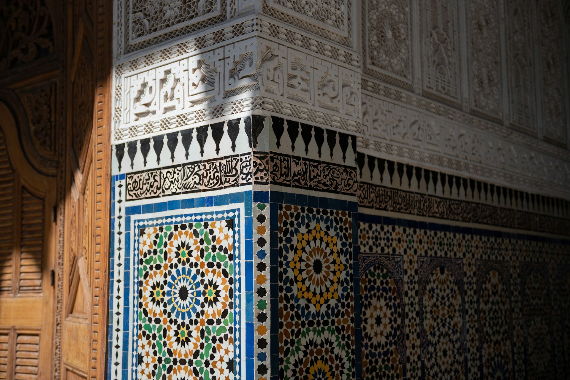 A tall building with a colorful tile design on it's side