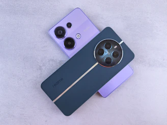 A couple of cell phones sitting next to each other