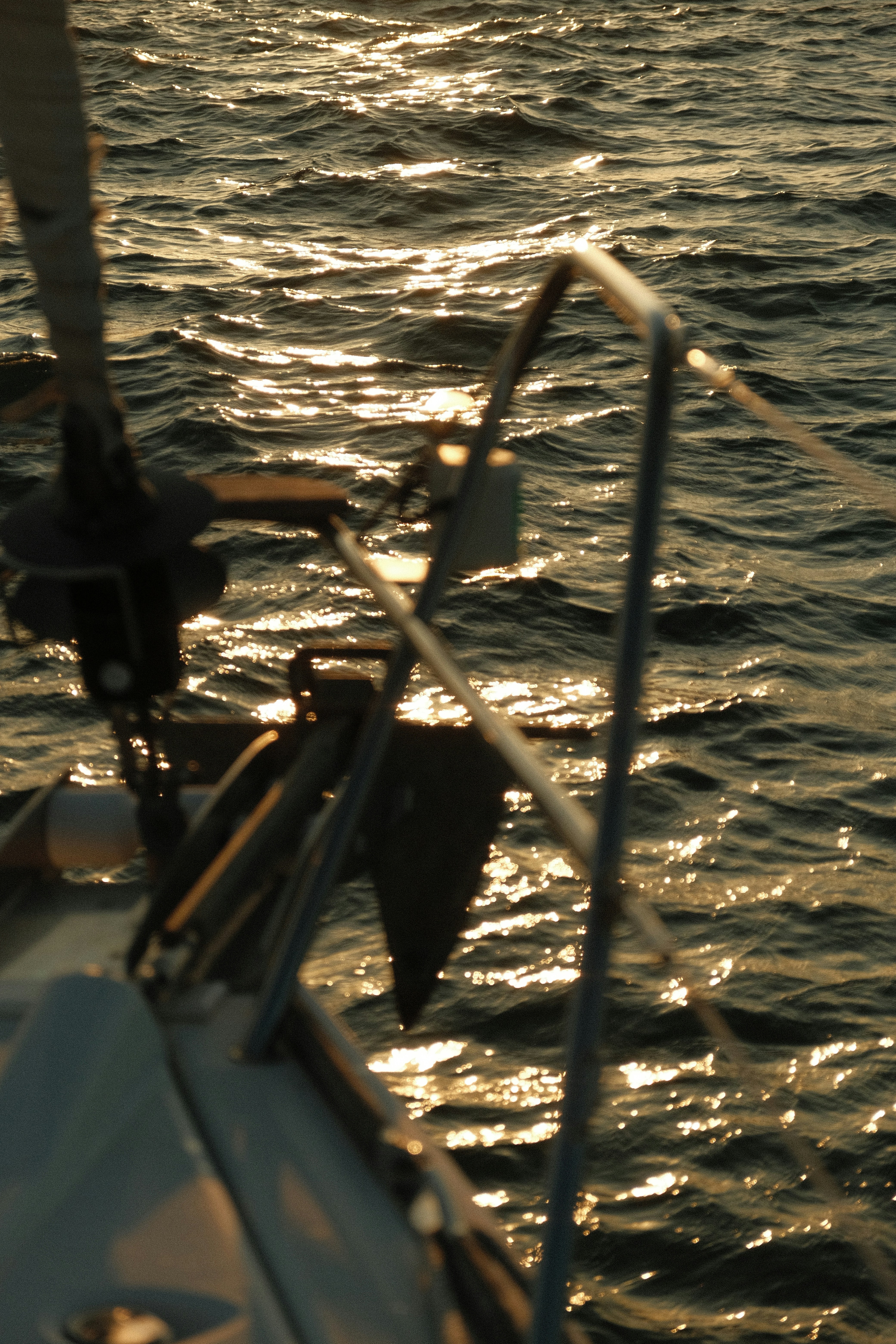 A sailboat in the water at sunset