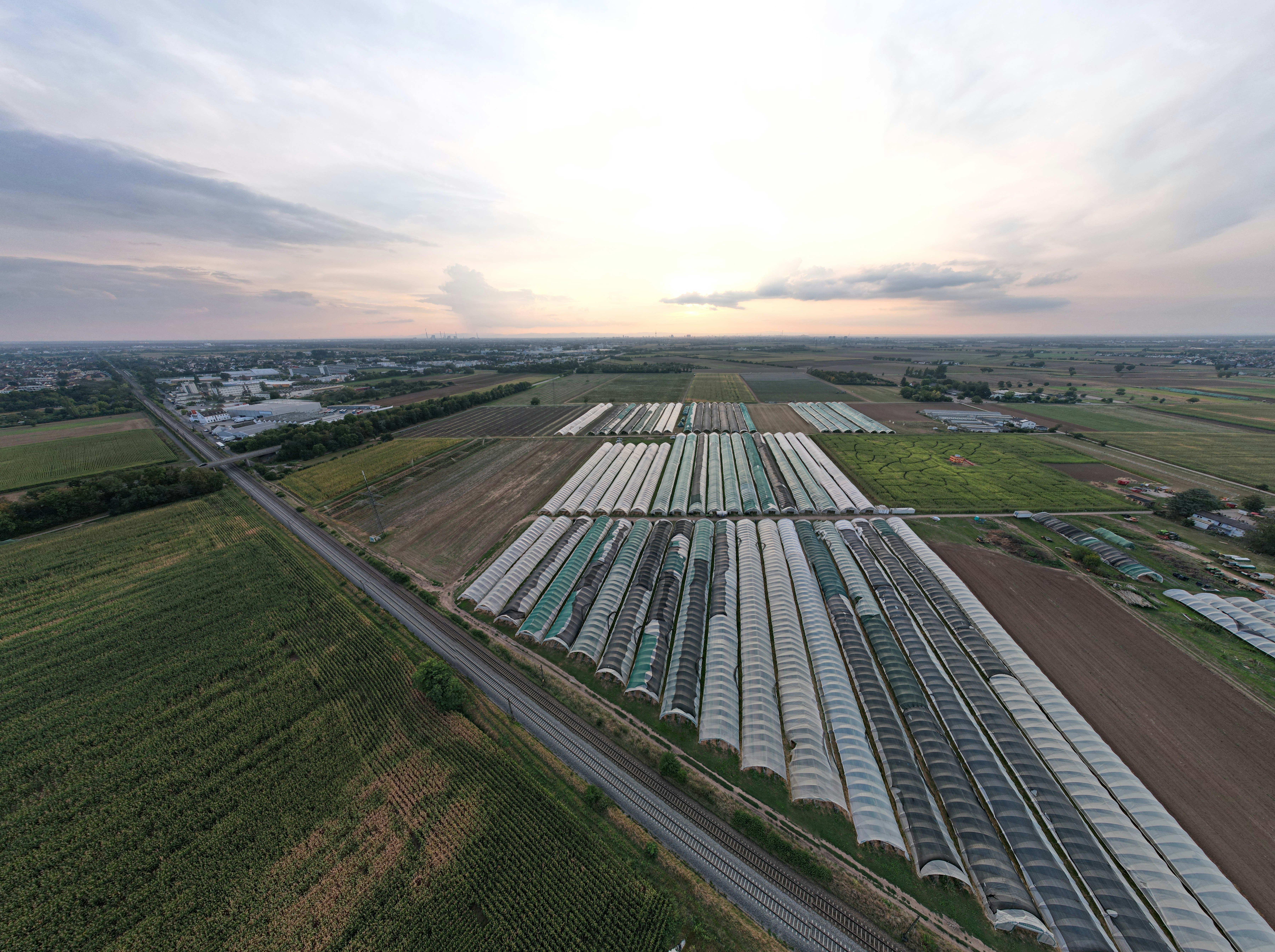 An aerial view of a train yard in a rural area