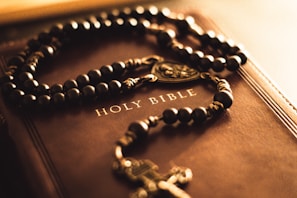 A book with a rosary and a cross on it