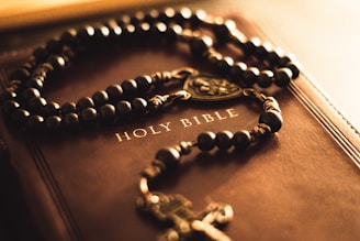 A book with a rosary and a cross on it