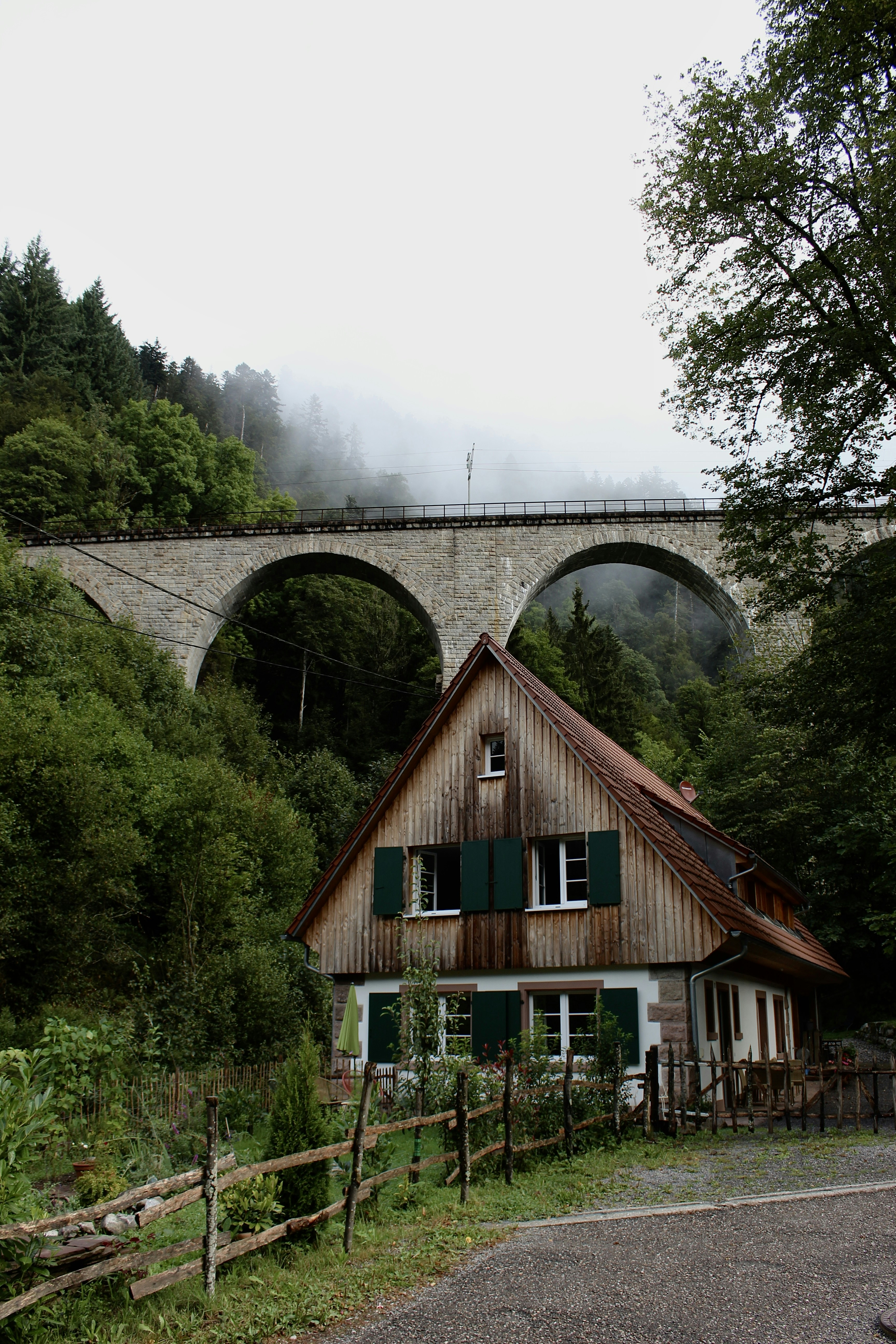 A house with a bridge in the background