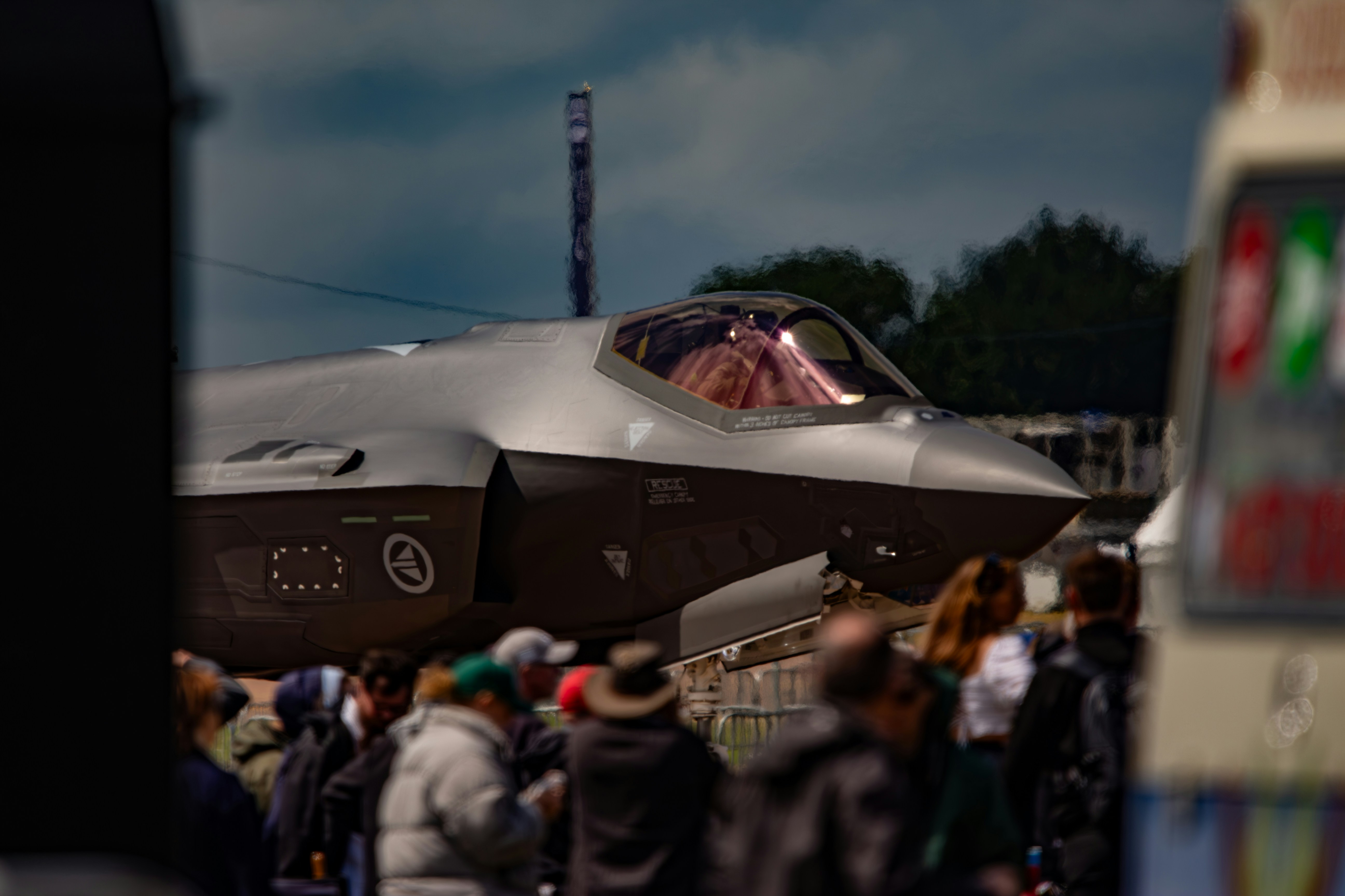 A crowd of people standing around a fighter jet photo – Free Man Image ...