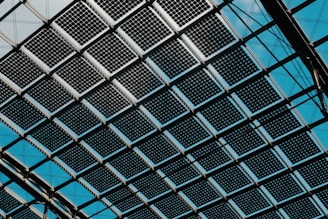 A close up of a metal structure with blue sky in the background