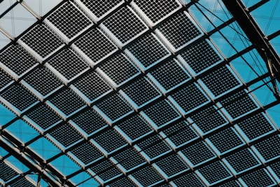 A close up of a metal structure with blue sky in the background