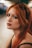 A woman with long red hair wearing sunglasses