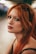 A woman with long red hair wearing sunglasses