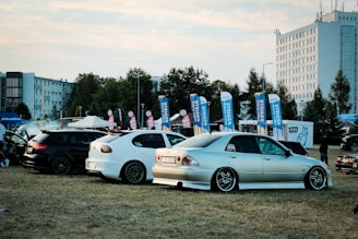 A group of cars parked next to each other in a field