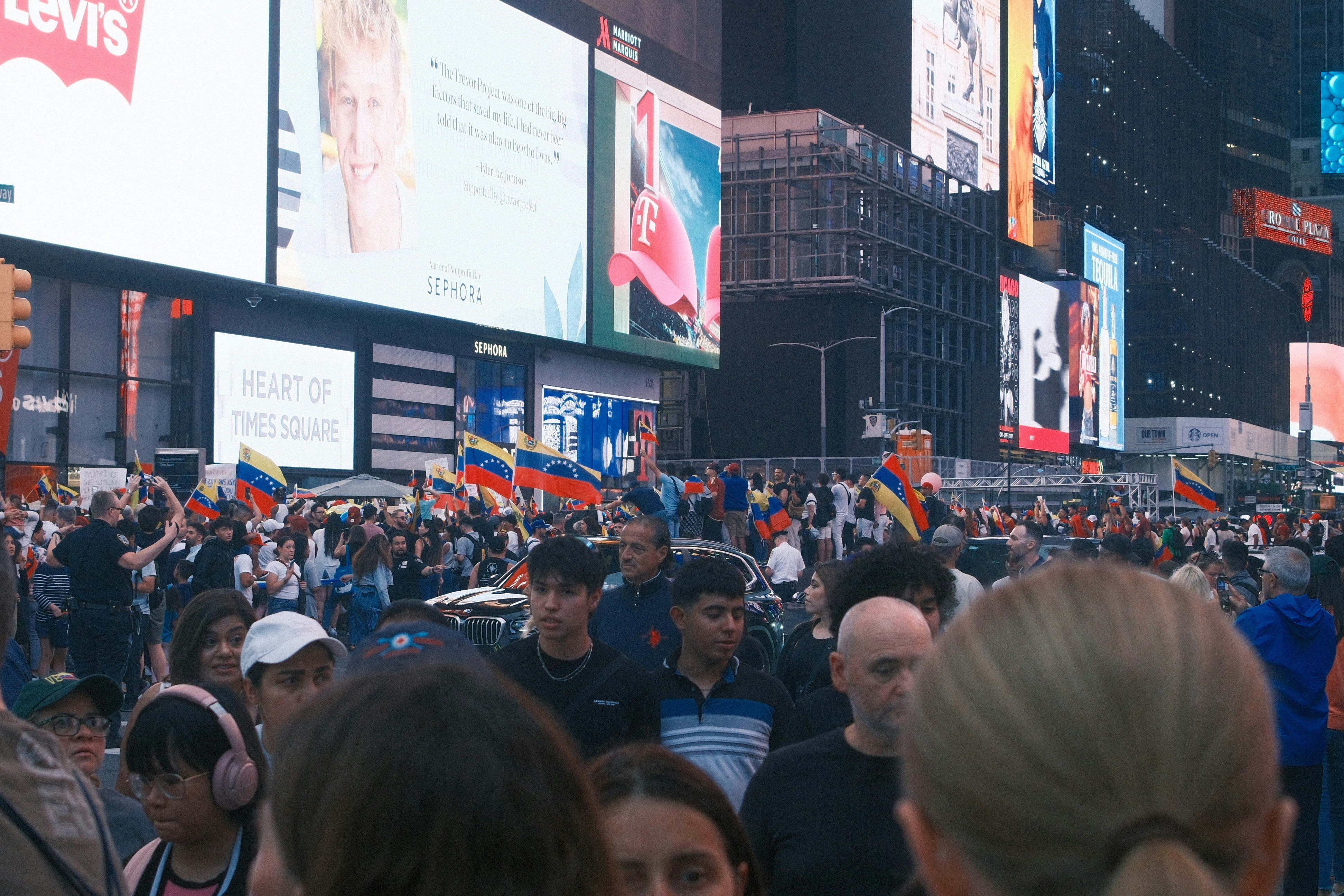 A large group of people standing in a crowded street