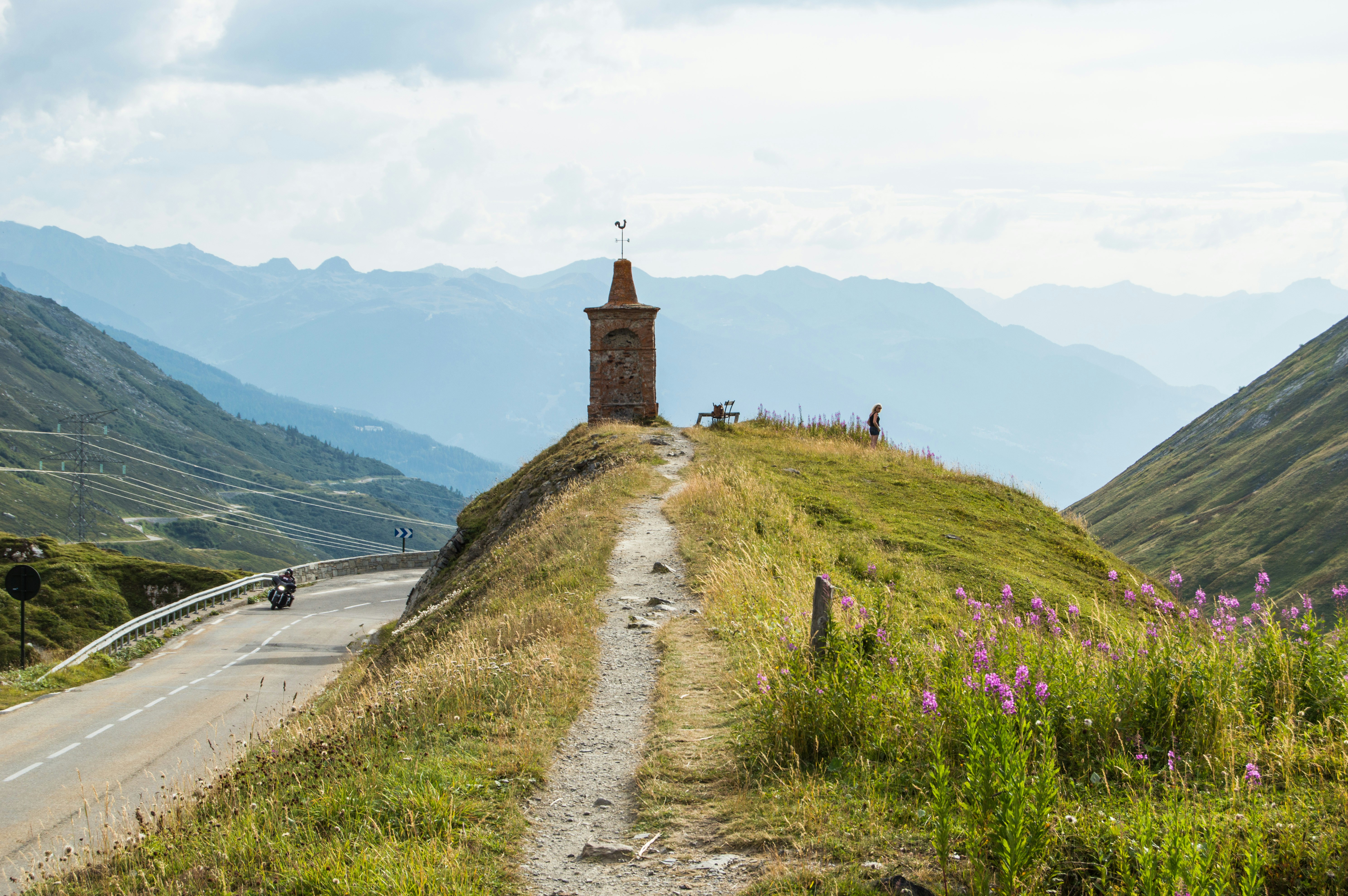 A road going up a hill with a tower on top