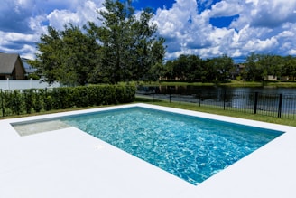 A swimming pool with a fence surrounding it