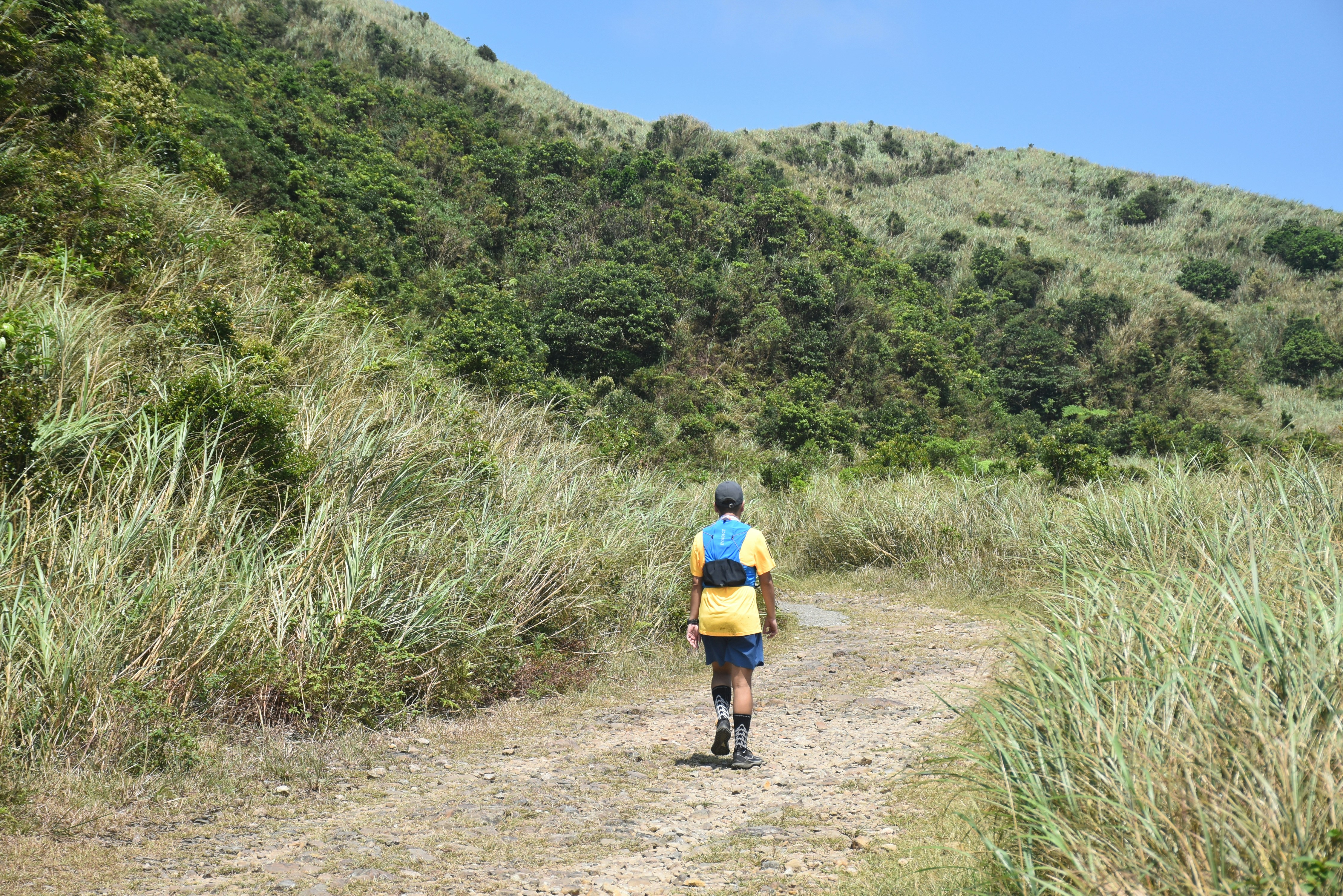 A person is running down a dirt road