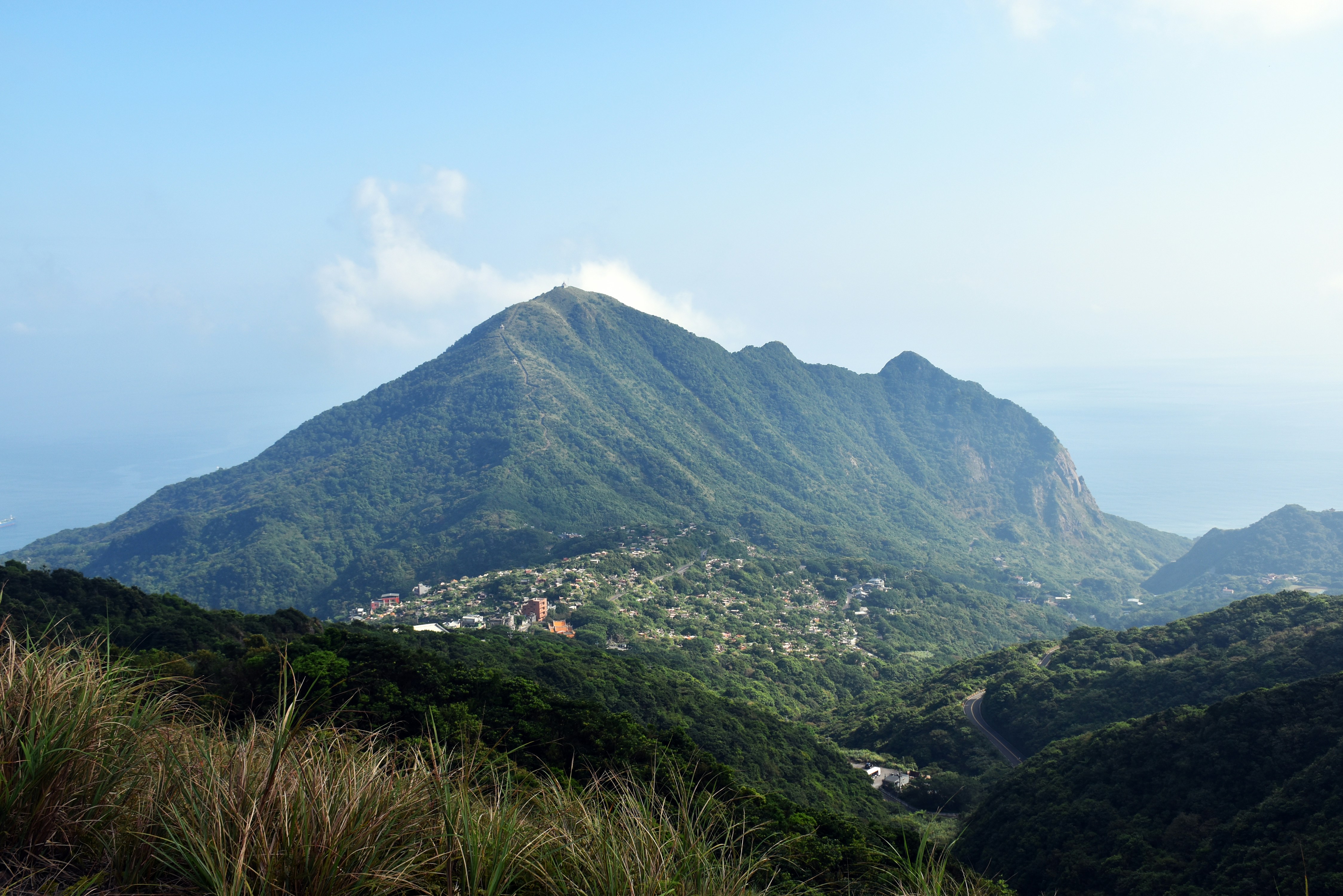A view of a mountain range with a town in the distance