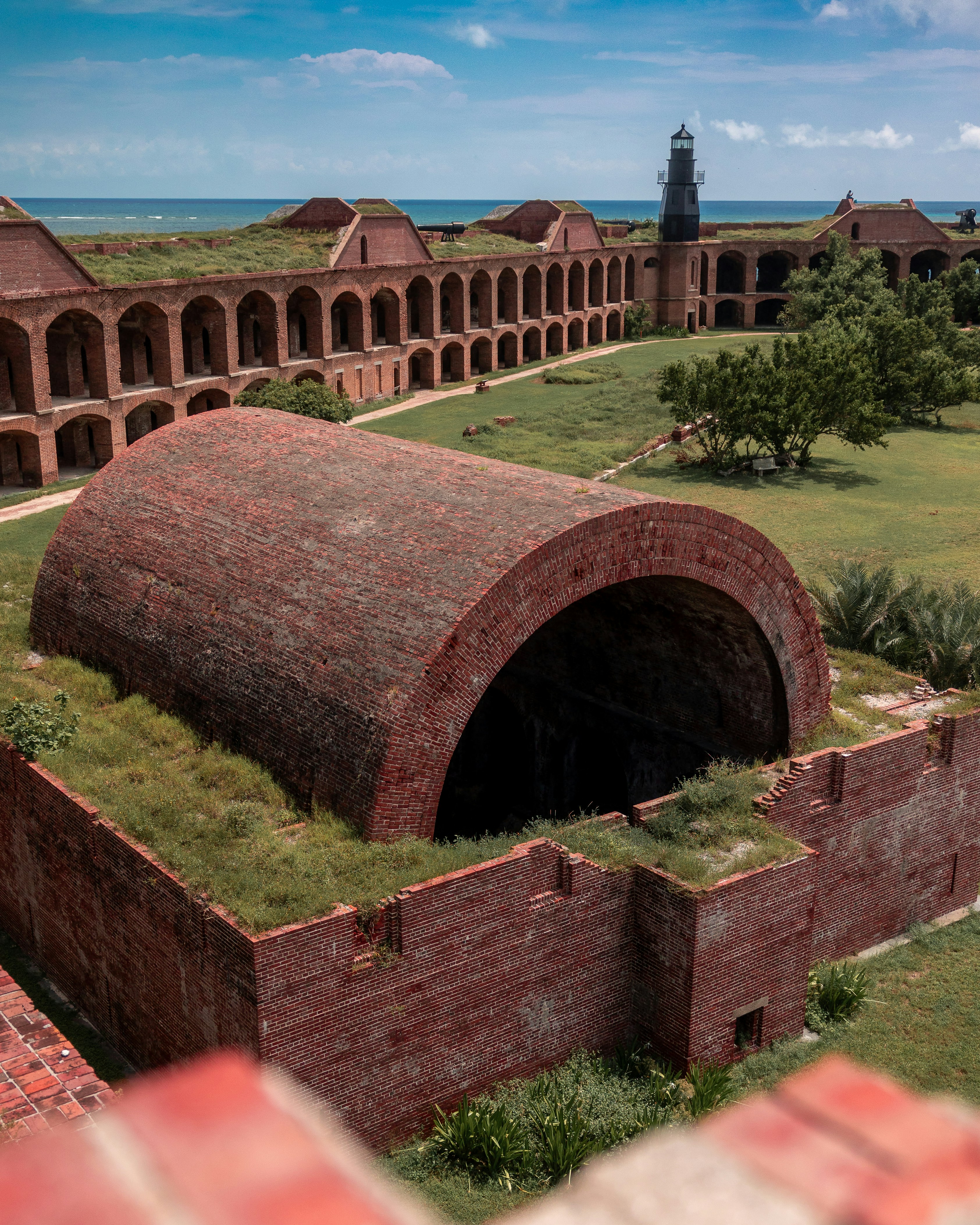 An aerial view of a brick building with a green roof