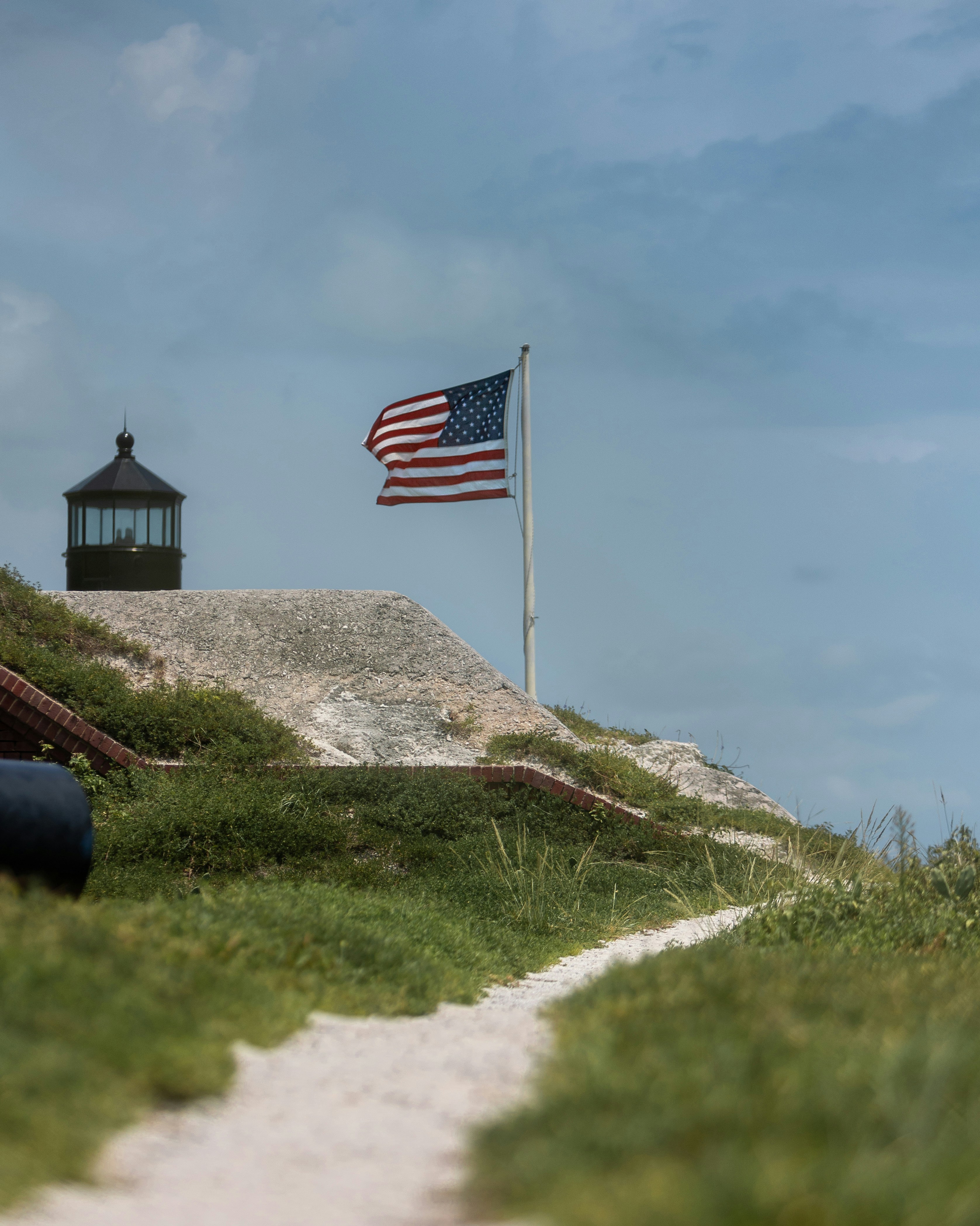 A lighthouse with a flag on top of it
