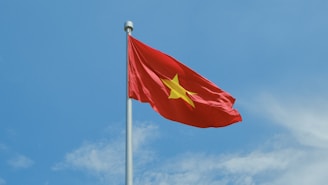 A chinese flag flying high in the sky
