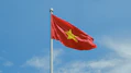 A chinese flag flying high in the sky