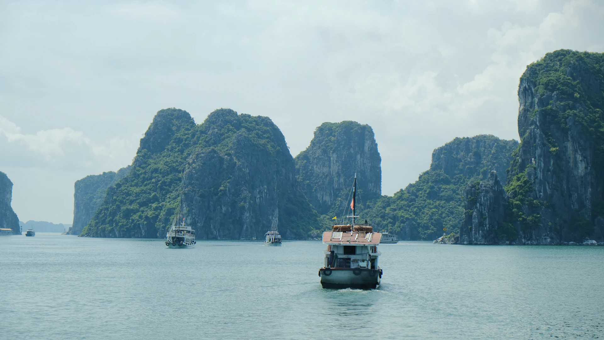 A group of boats floating on top of a large body of water