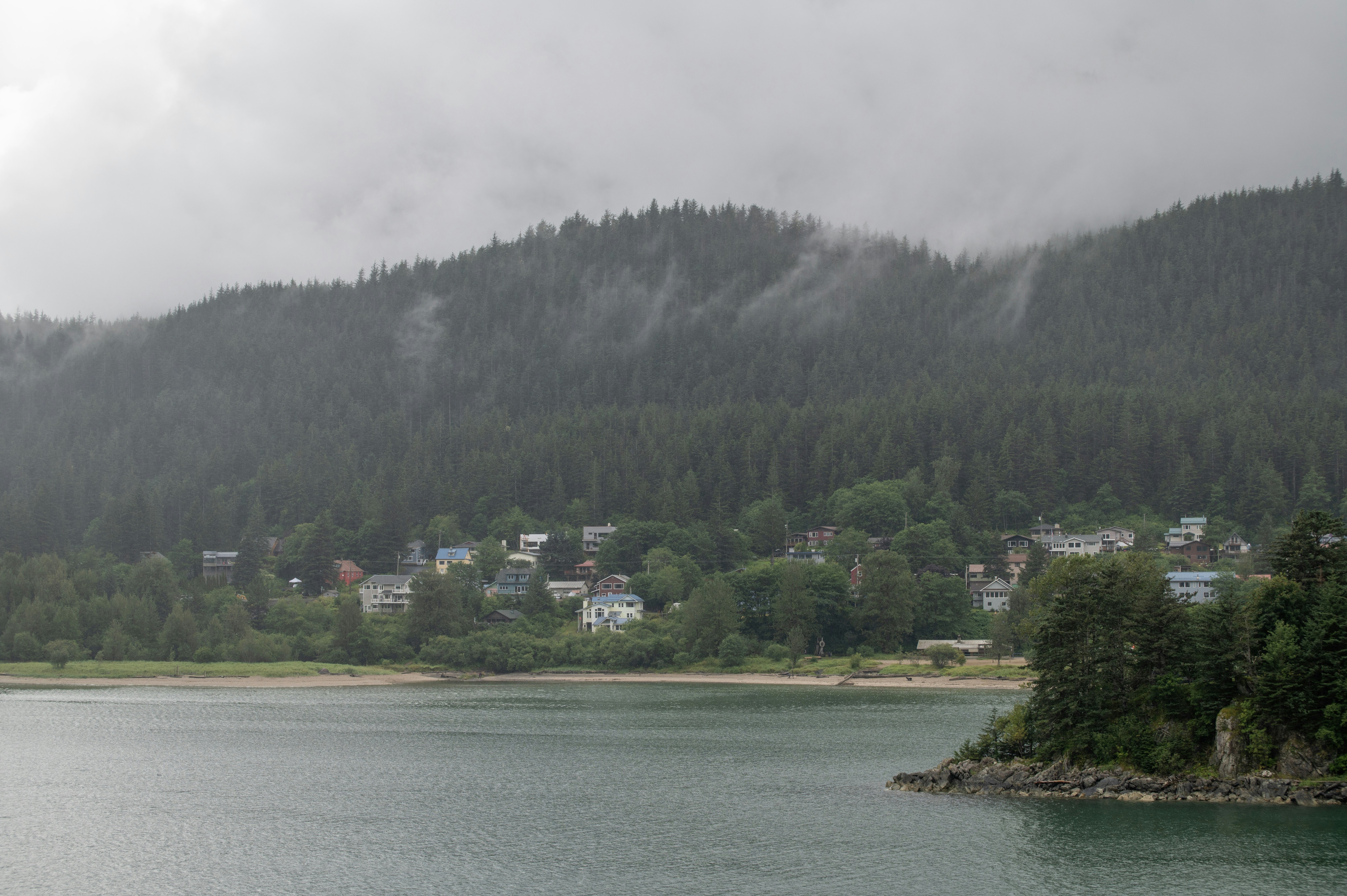 A body of water with a mountain in the background