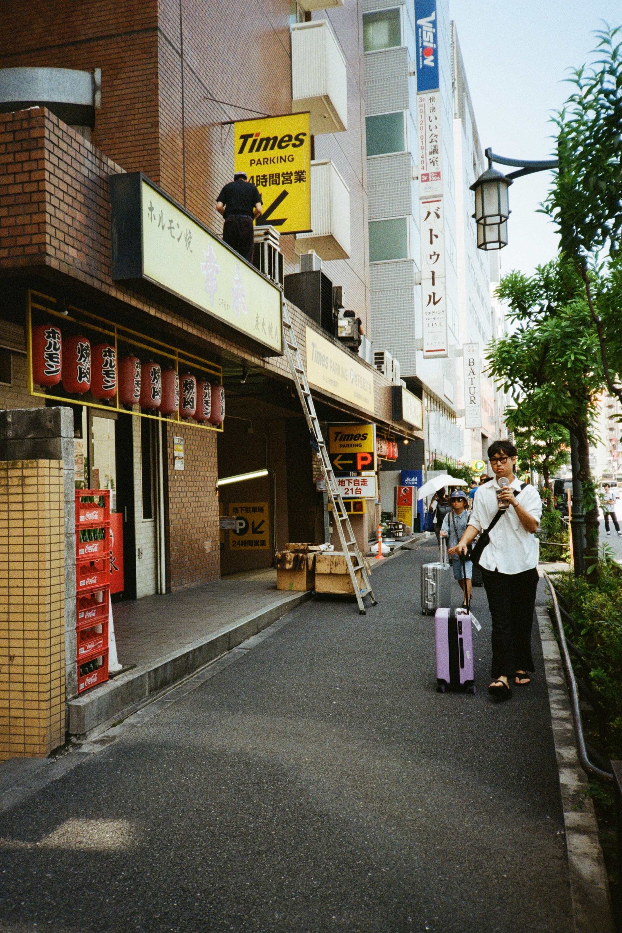 A couple of people that are walking down a street