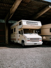 A couple of rvs parked in a garage