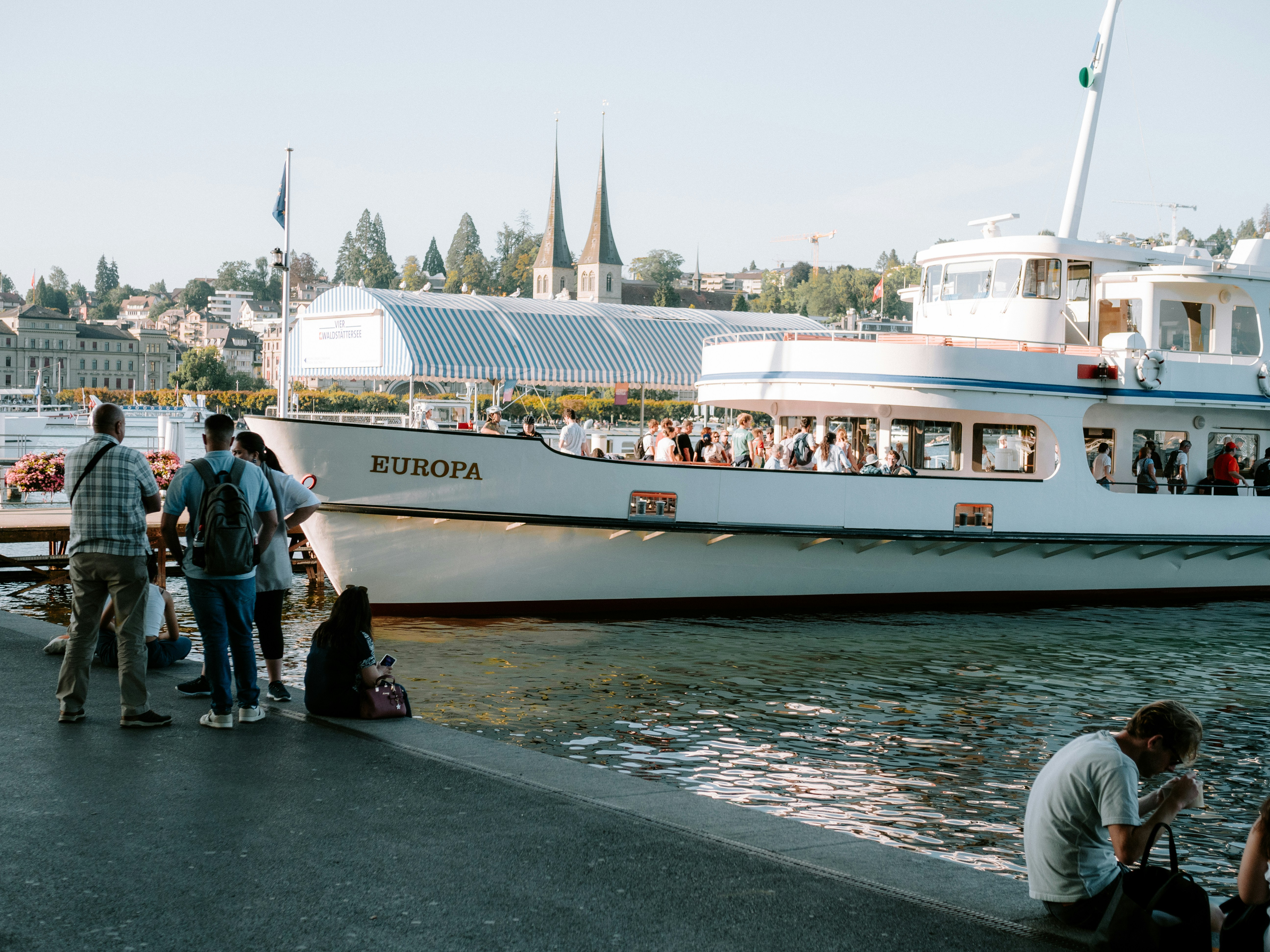 A group of people standing next to a boat