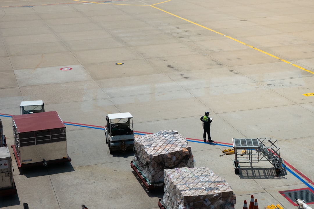 A man standing on the tarmac of an airport,