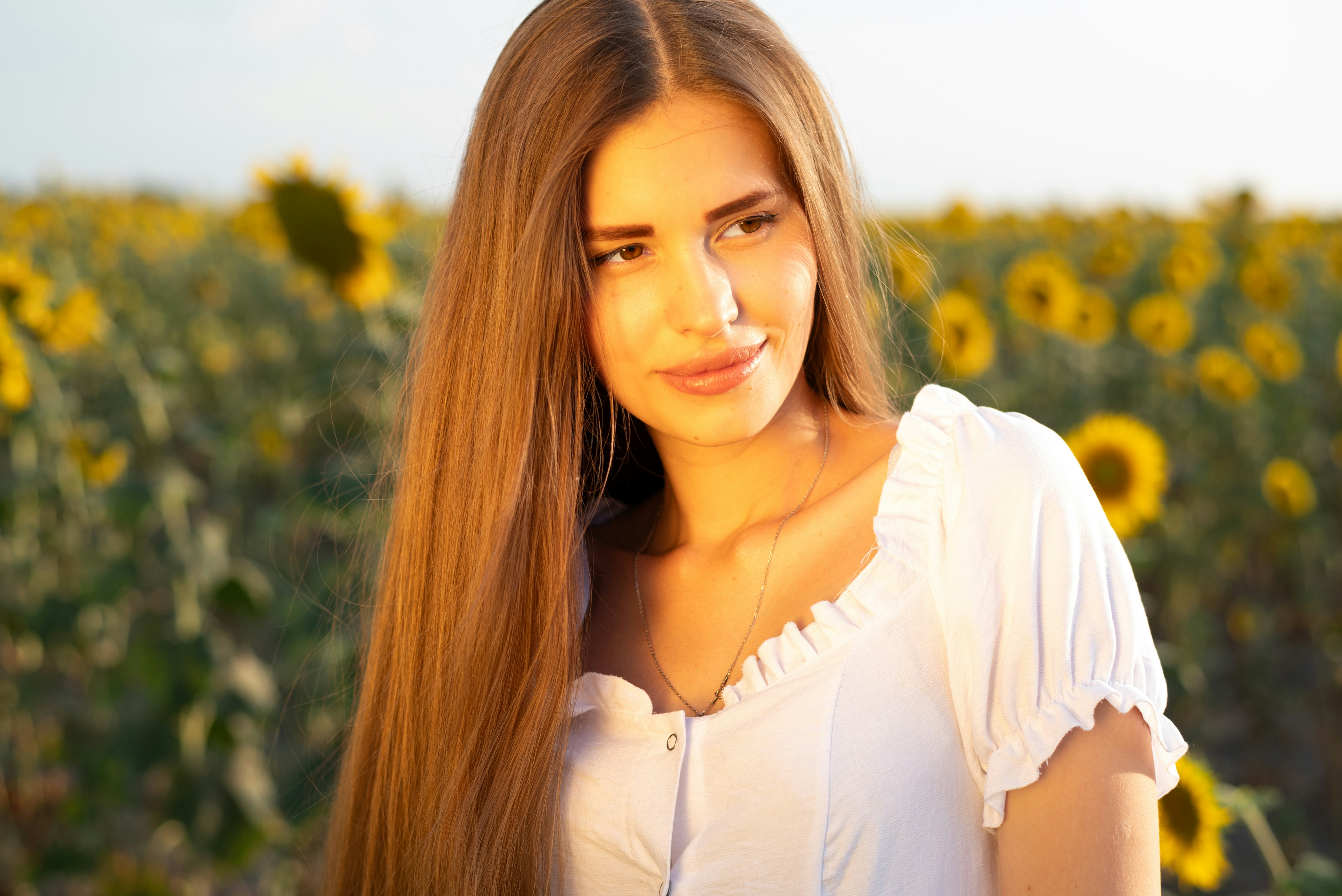 A woman standing in a field of sunflowers