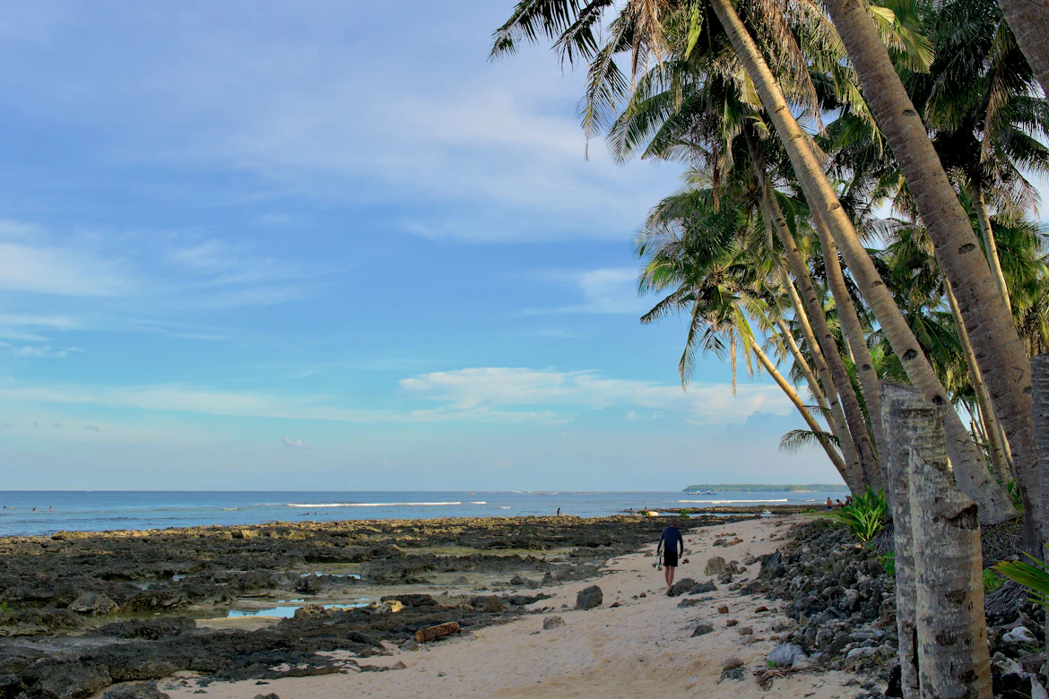 Surfer riding a clear wave at Cloud 9, Siargao