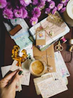 A desk with a bunch of papers and a cup of coffee