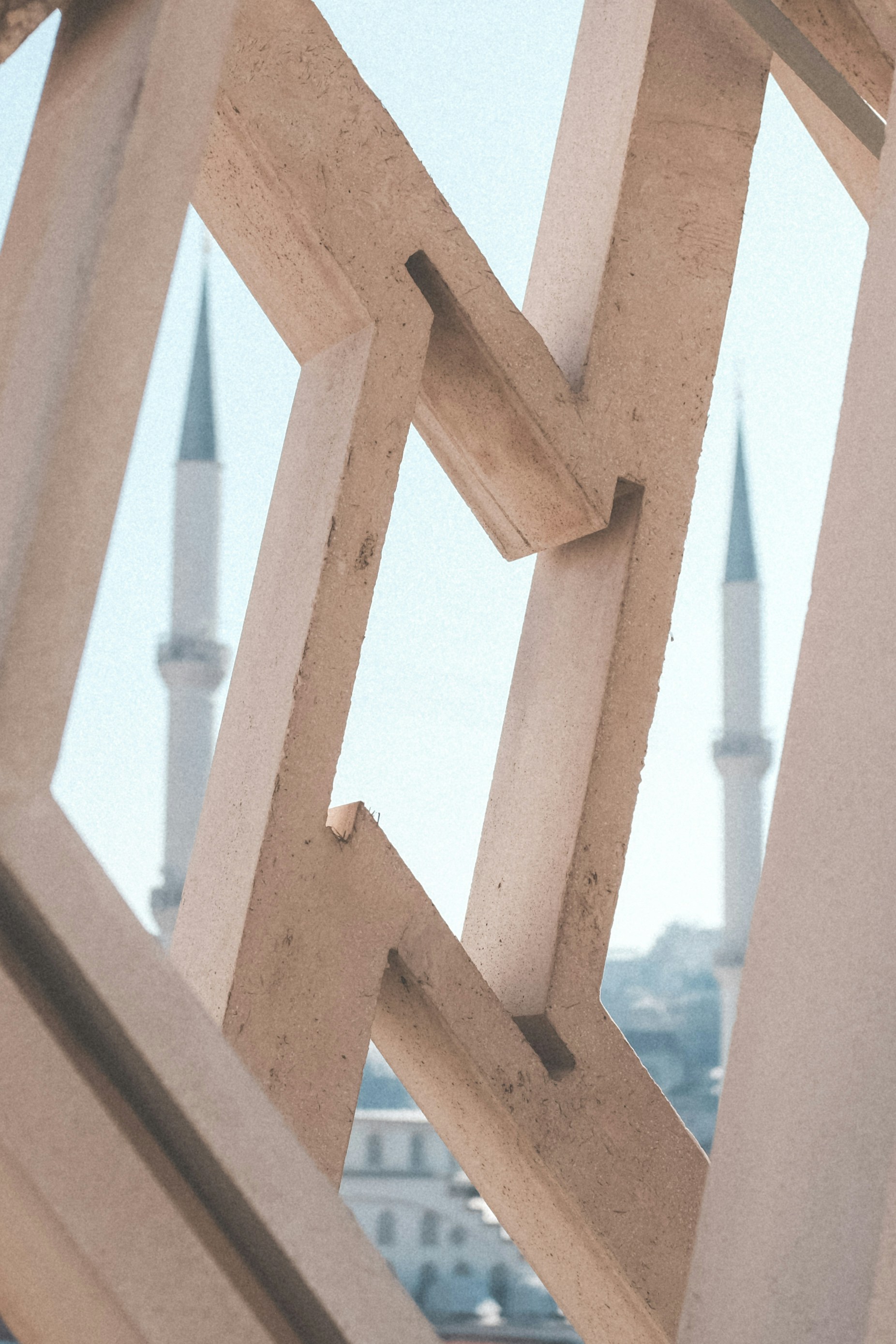 A close up of a wooden structure with a building in the background