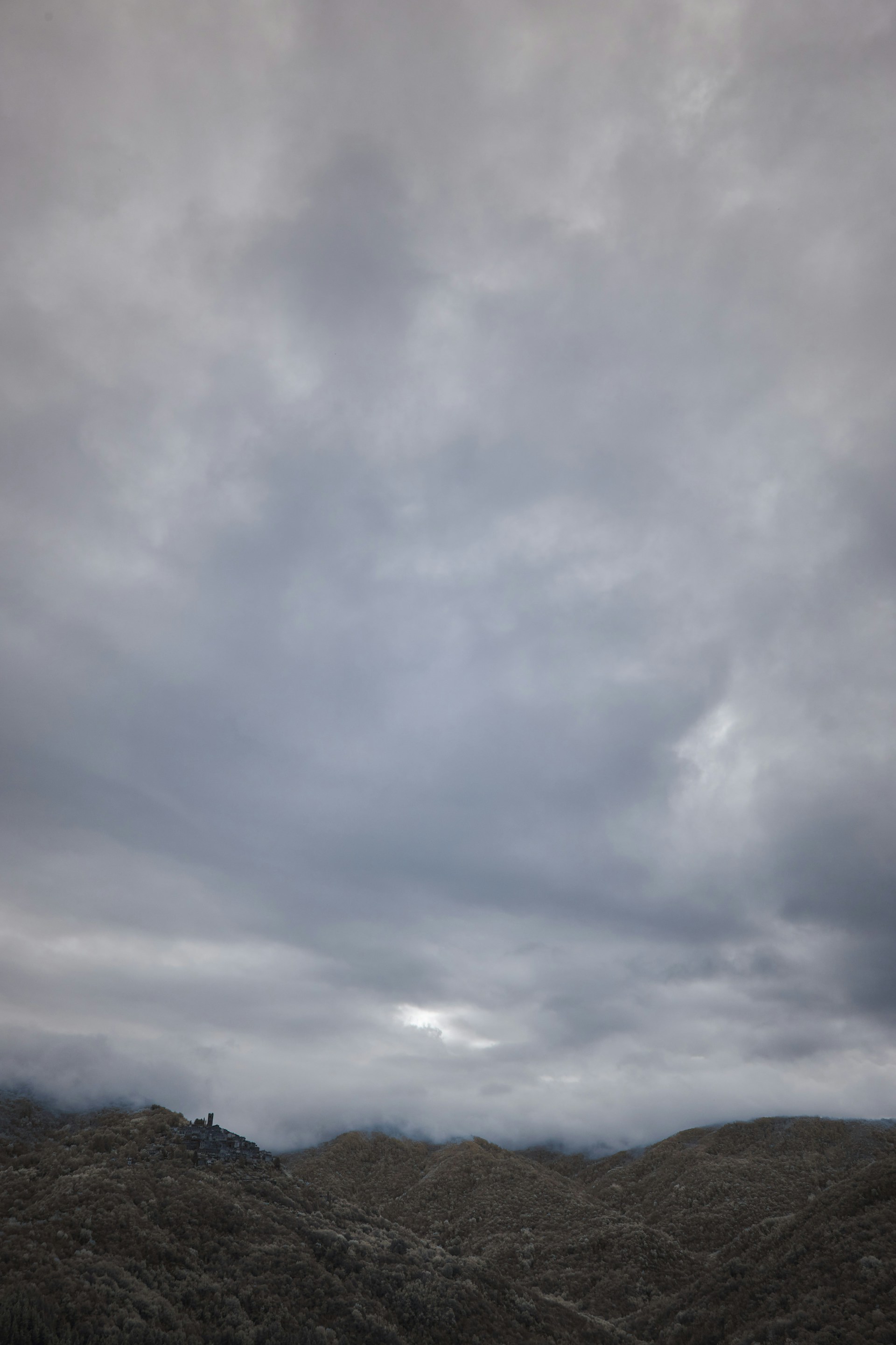A cloudy sky is seen over a mountain range