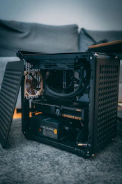 A black computer case sitting on top of a carpeted floor