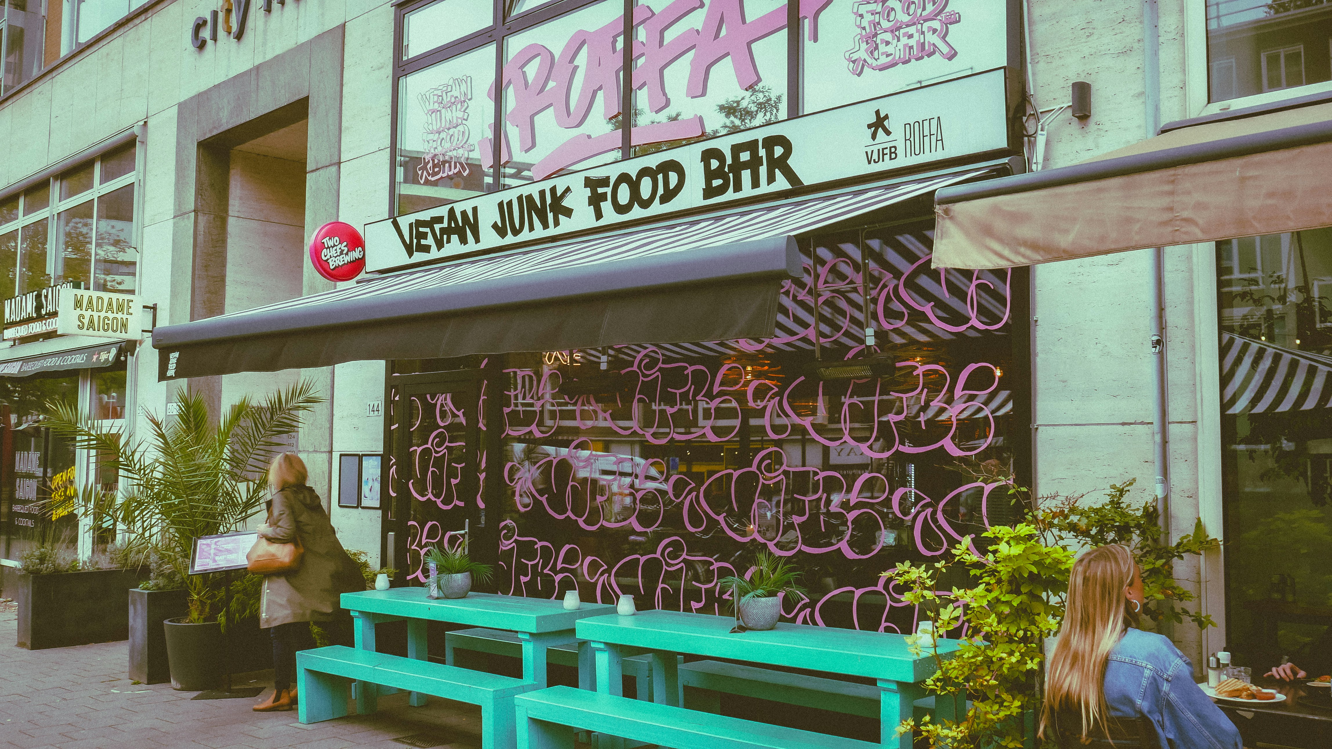 A green bench sitting in front of a building