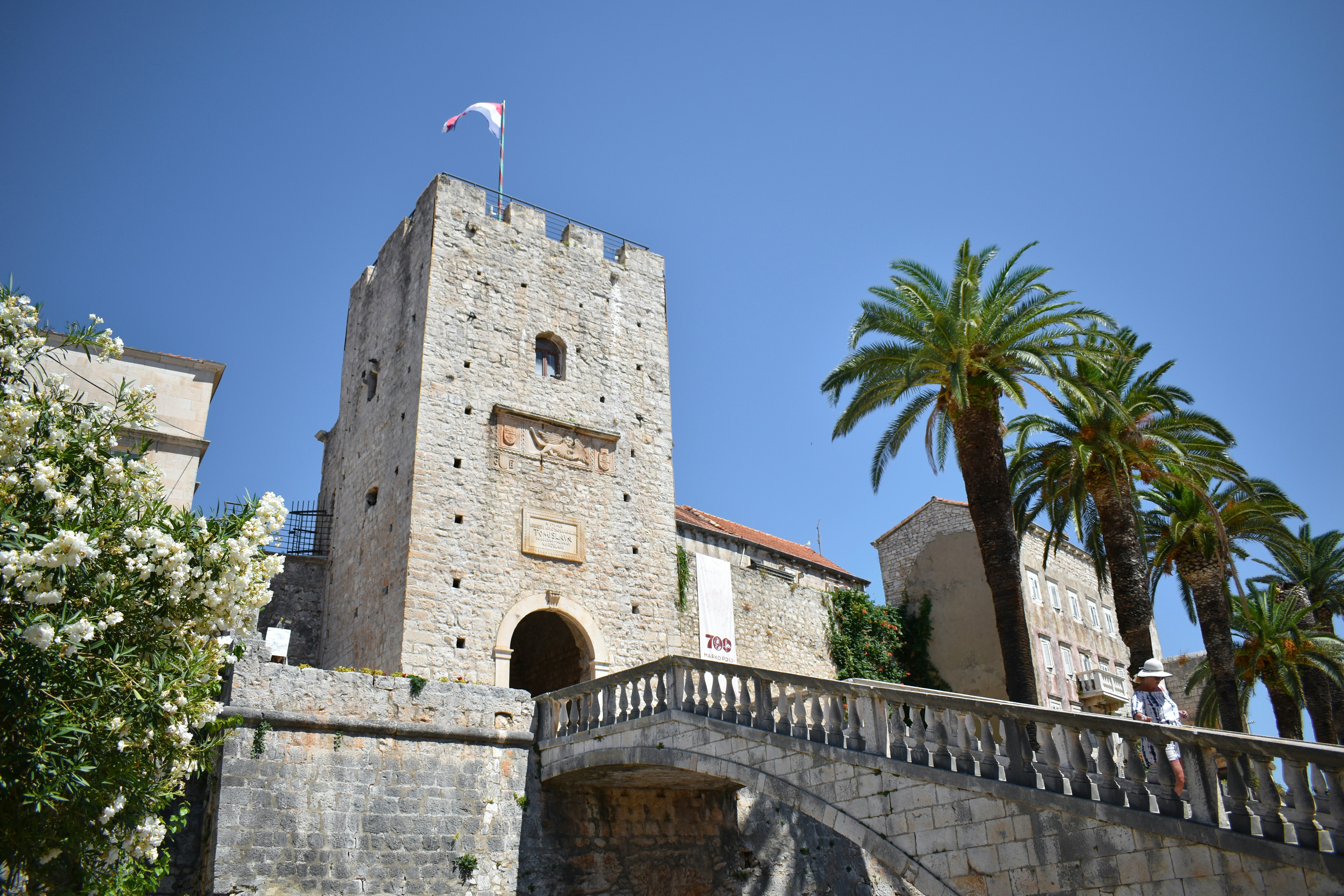 A stone bridge with a clock tower in the background