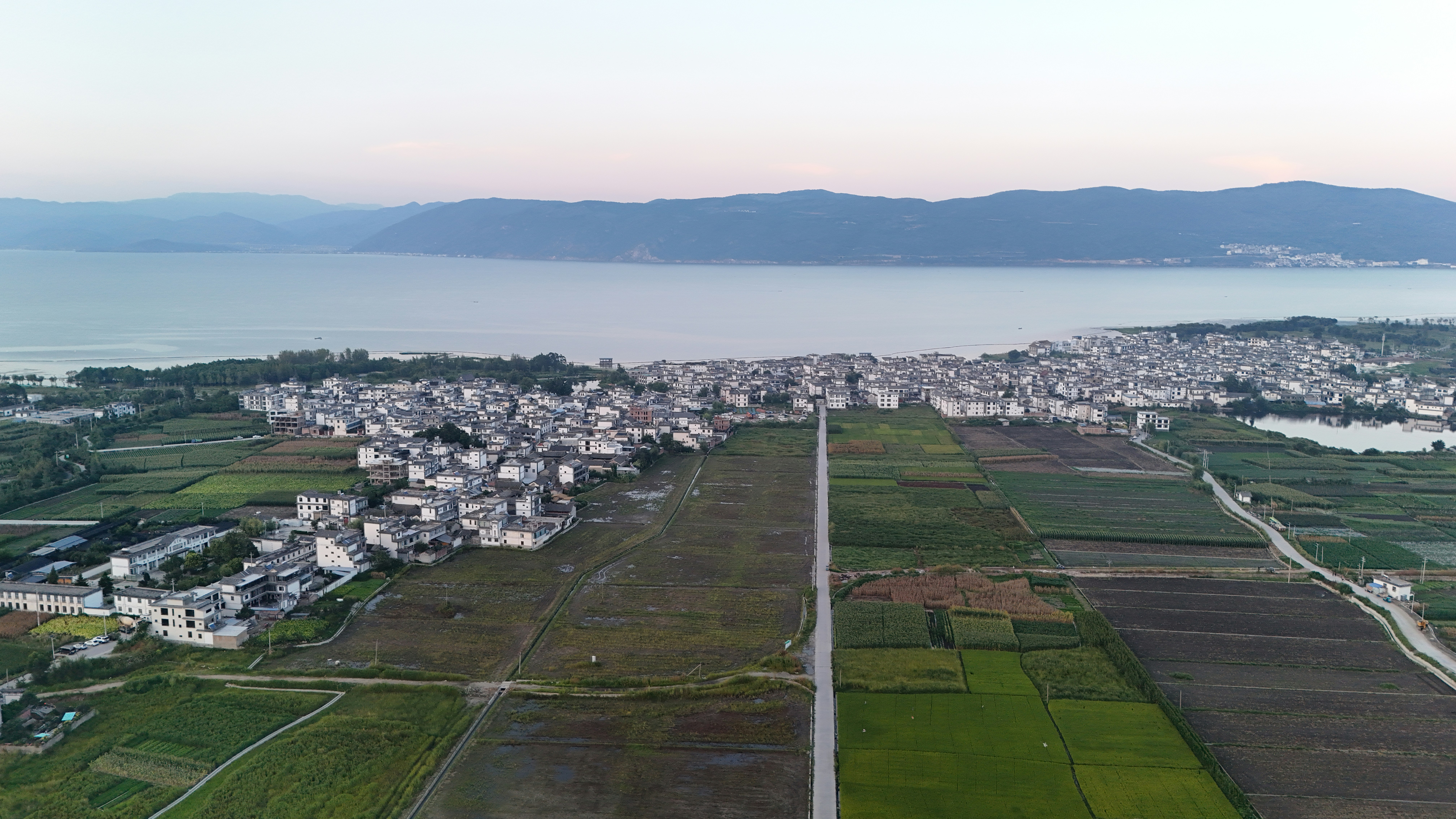 An aerial view of a town and a body of water