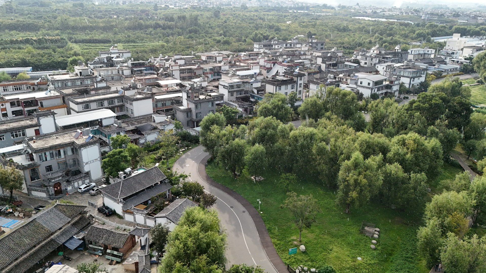 Aerial view of village buildings in Dali, Yunnan, showing peaceful residential communities suitable for long-term stays