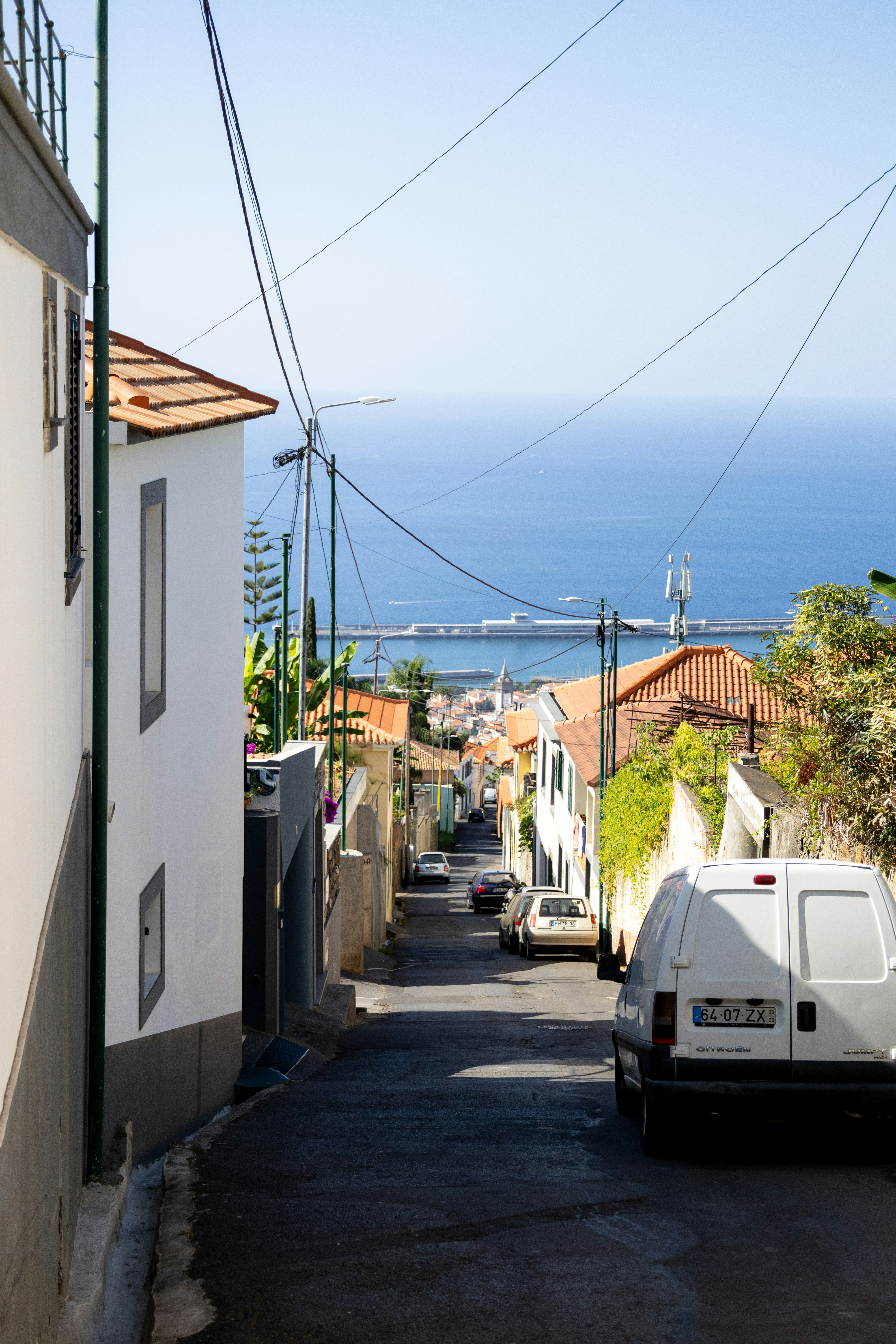 A white van parked on the side of a road